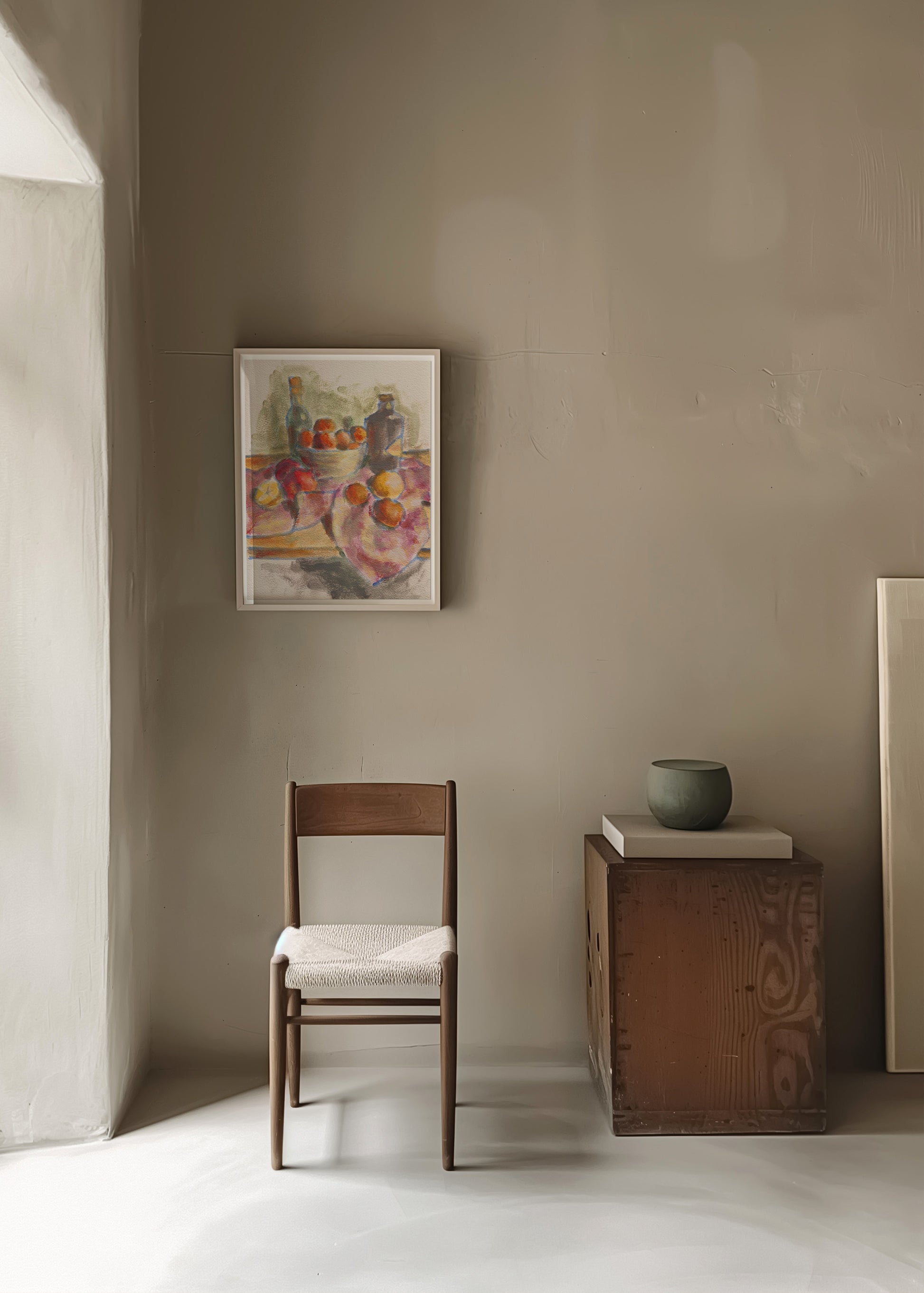 Room interior with a chair, small table, and framed artwork on a beige wall.
