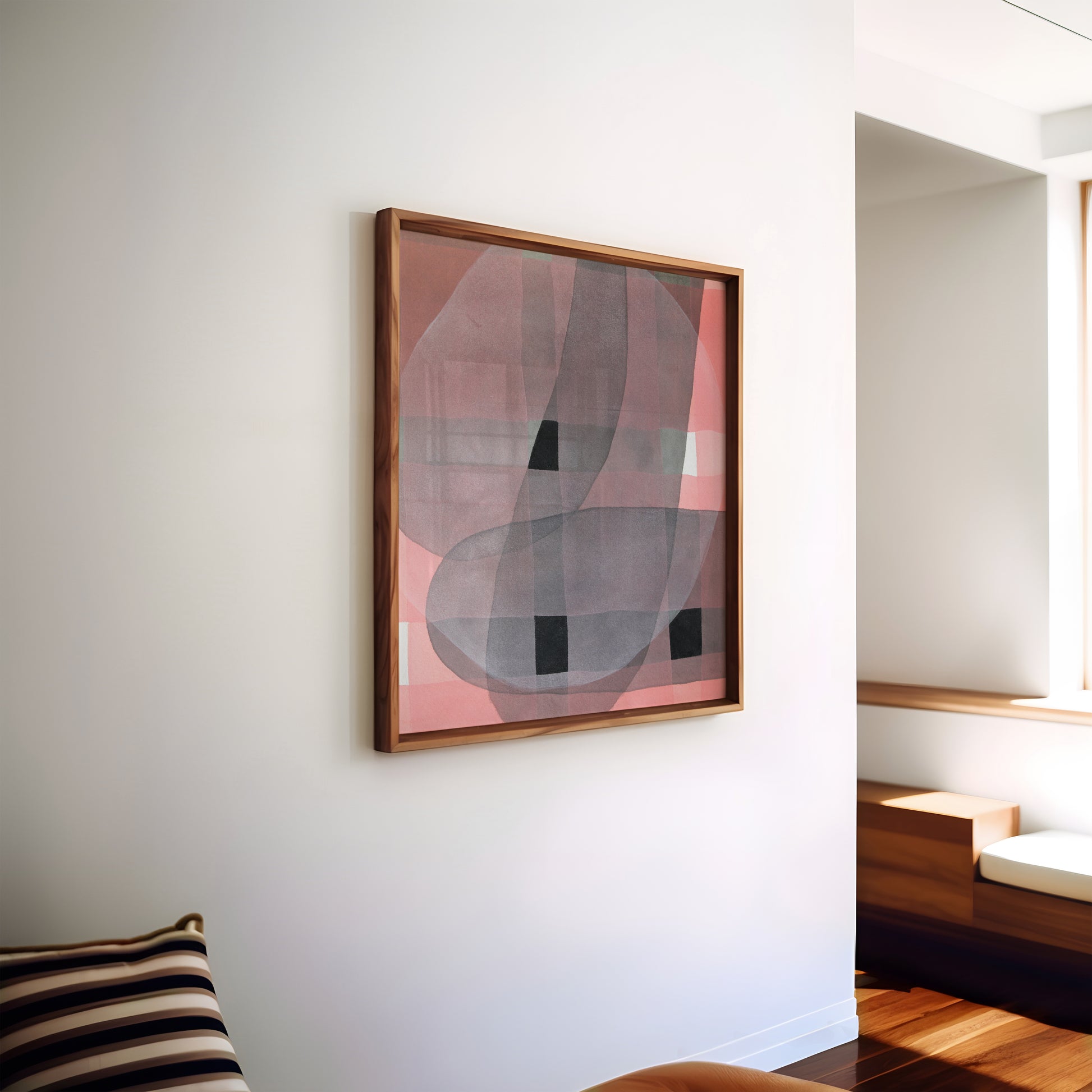 Abstract art piece in a wooden frame on a white wall