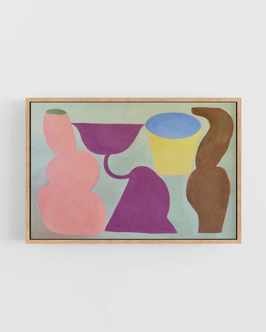 Framed abstract artwork with colorful shapes on a white wall.