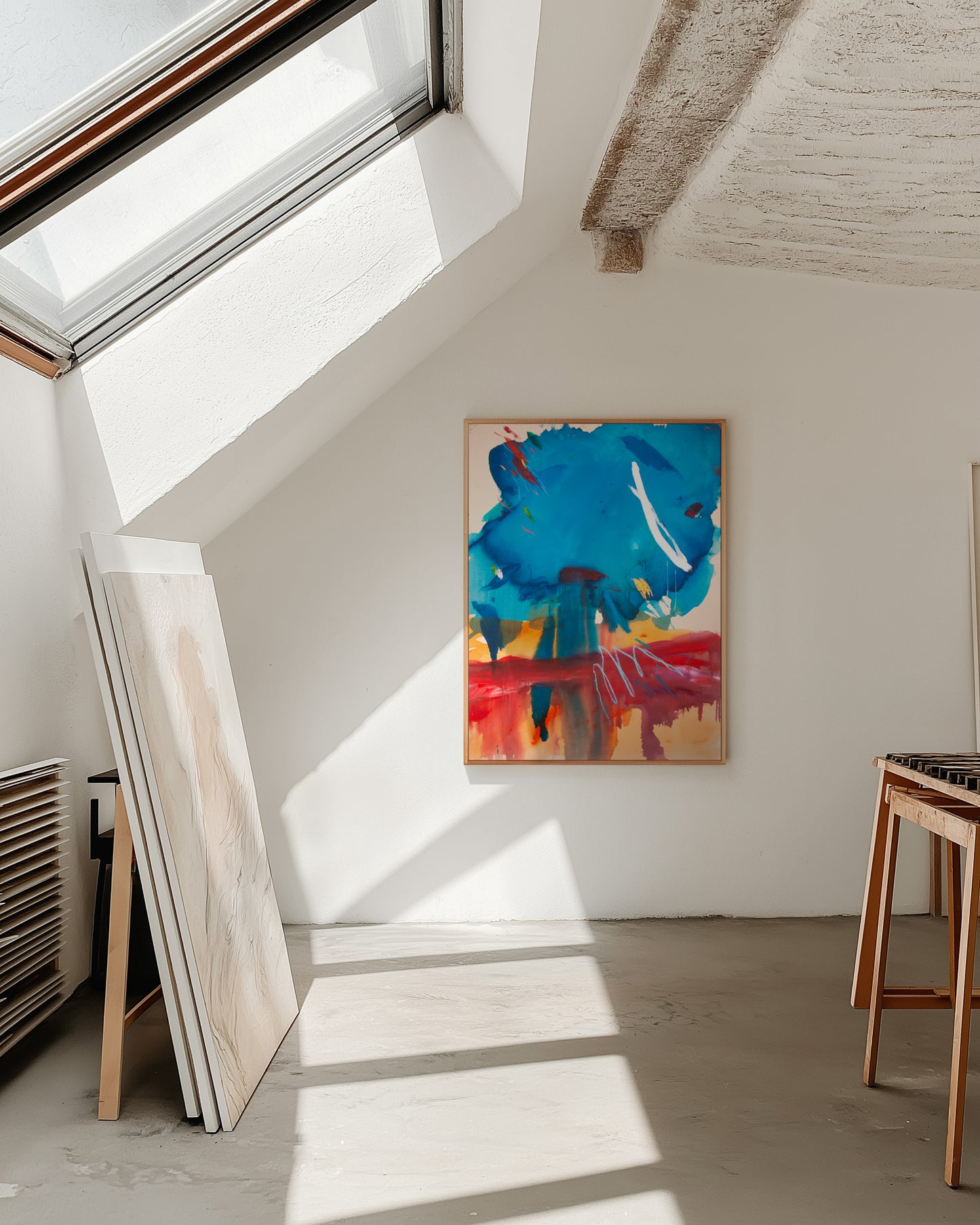 Colorful abstract painting on the wall of an artist's studio with a sunlight.