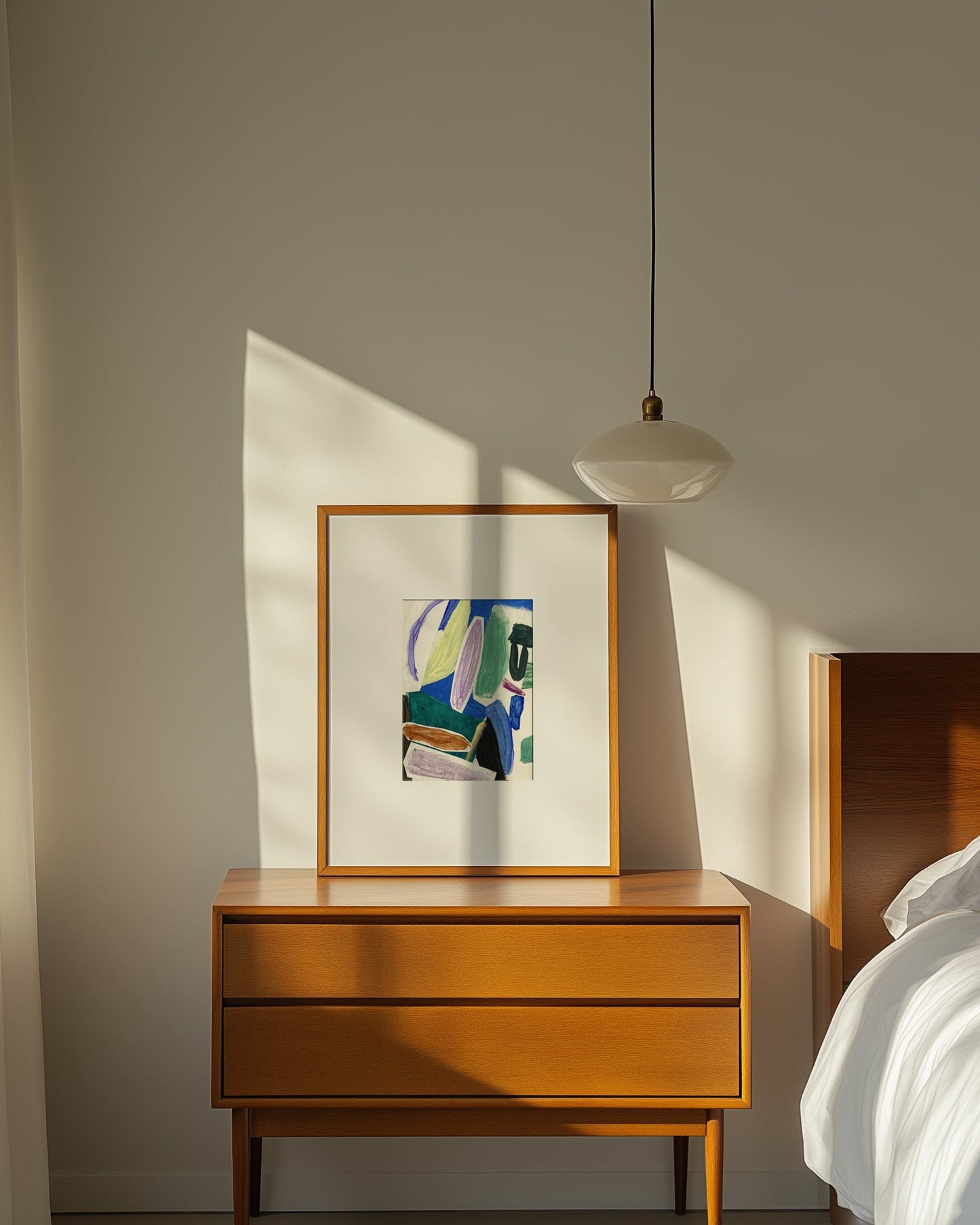 Framed abstract art on beside table.