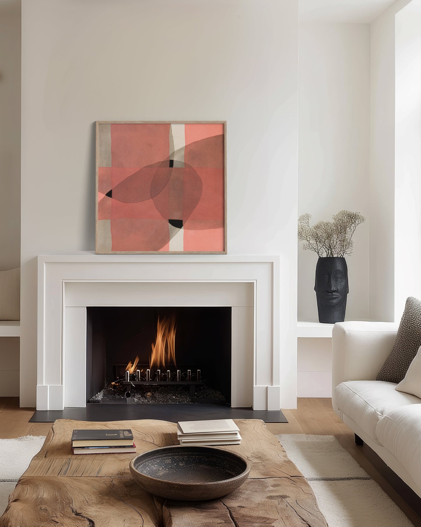 Living room with a fireplace with an abstract painting leaning on the mantle.