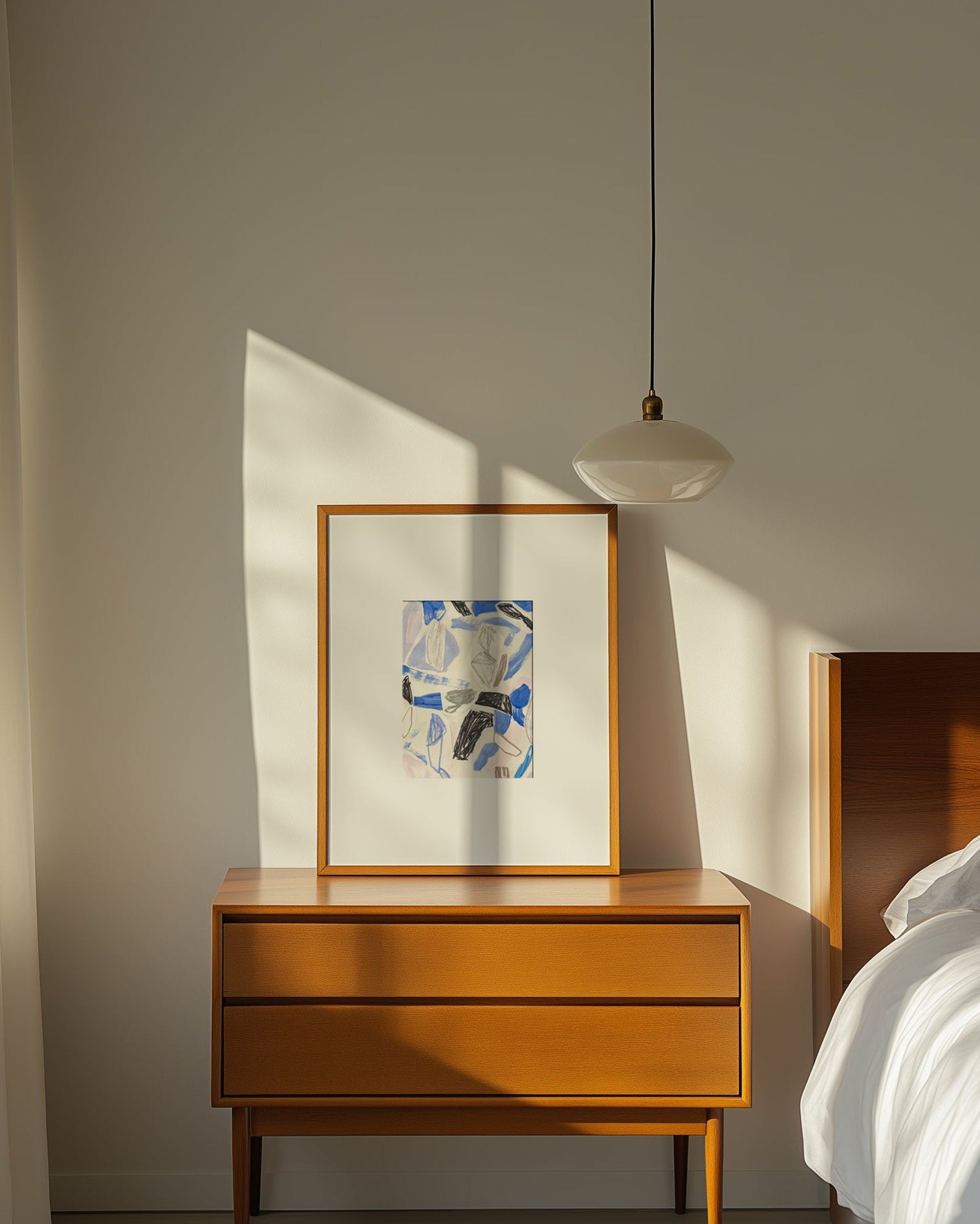 Framed abstract art on wooden beside table