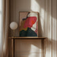 Abstract painting on a wooden table in a sophisticated room with wall molding.