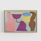Framed abstract artwork with colorful shapes on a white wall.