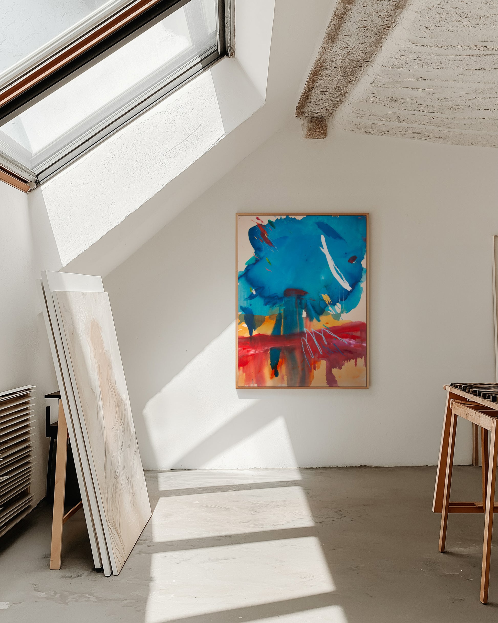 Colorful abstract painting on the wall of an artist's studio with a sunlight.