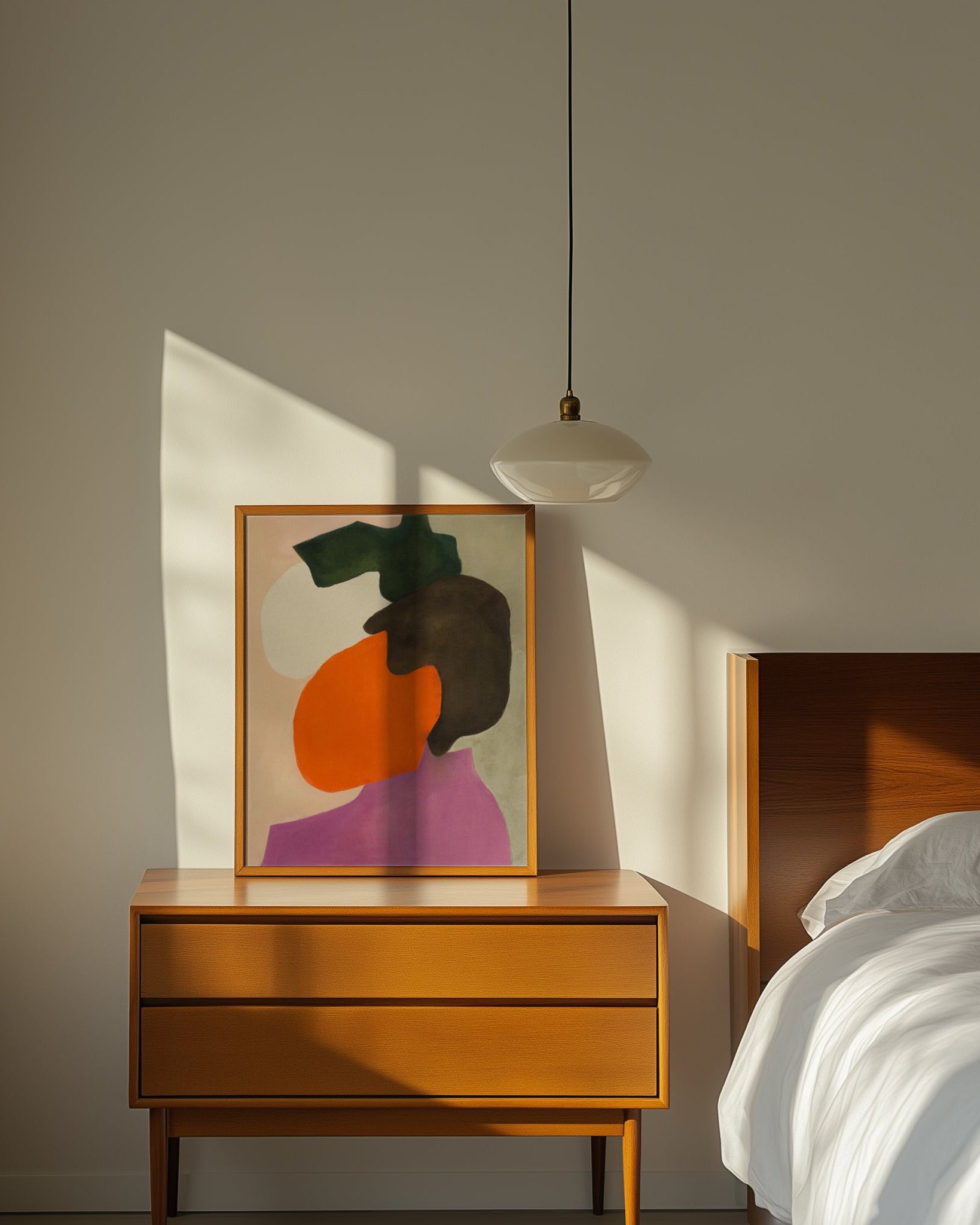 Abstract art on wooden nightstand in a bedroom.