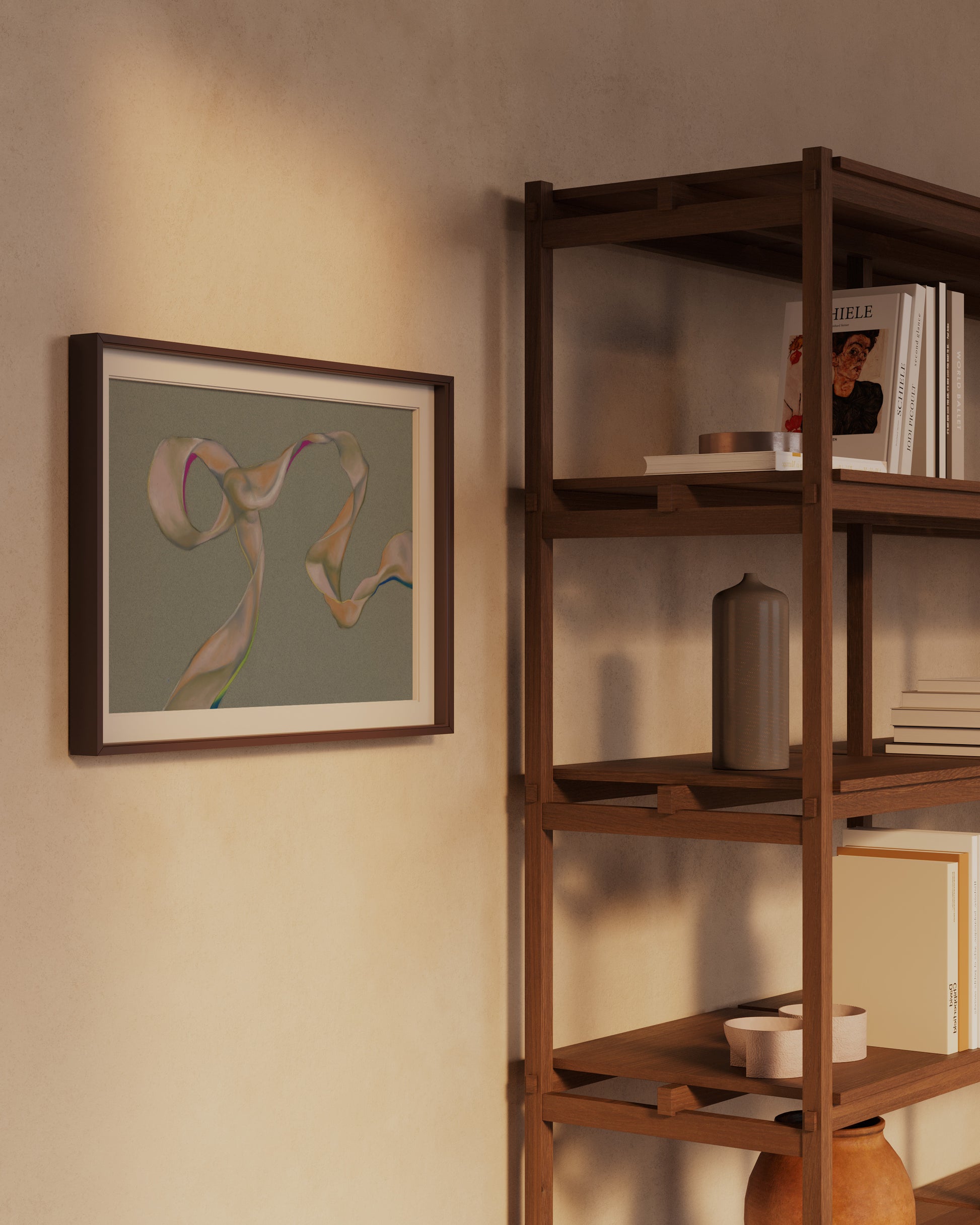 Framed abstract art on a wall next to a wooden bookshelf with books and decor items.