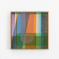 Framed abstract art with colorful geometric design on a white background