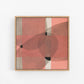 Framed abstract art piece with geometric pink and black shapes.