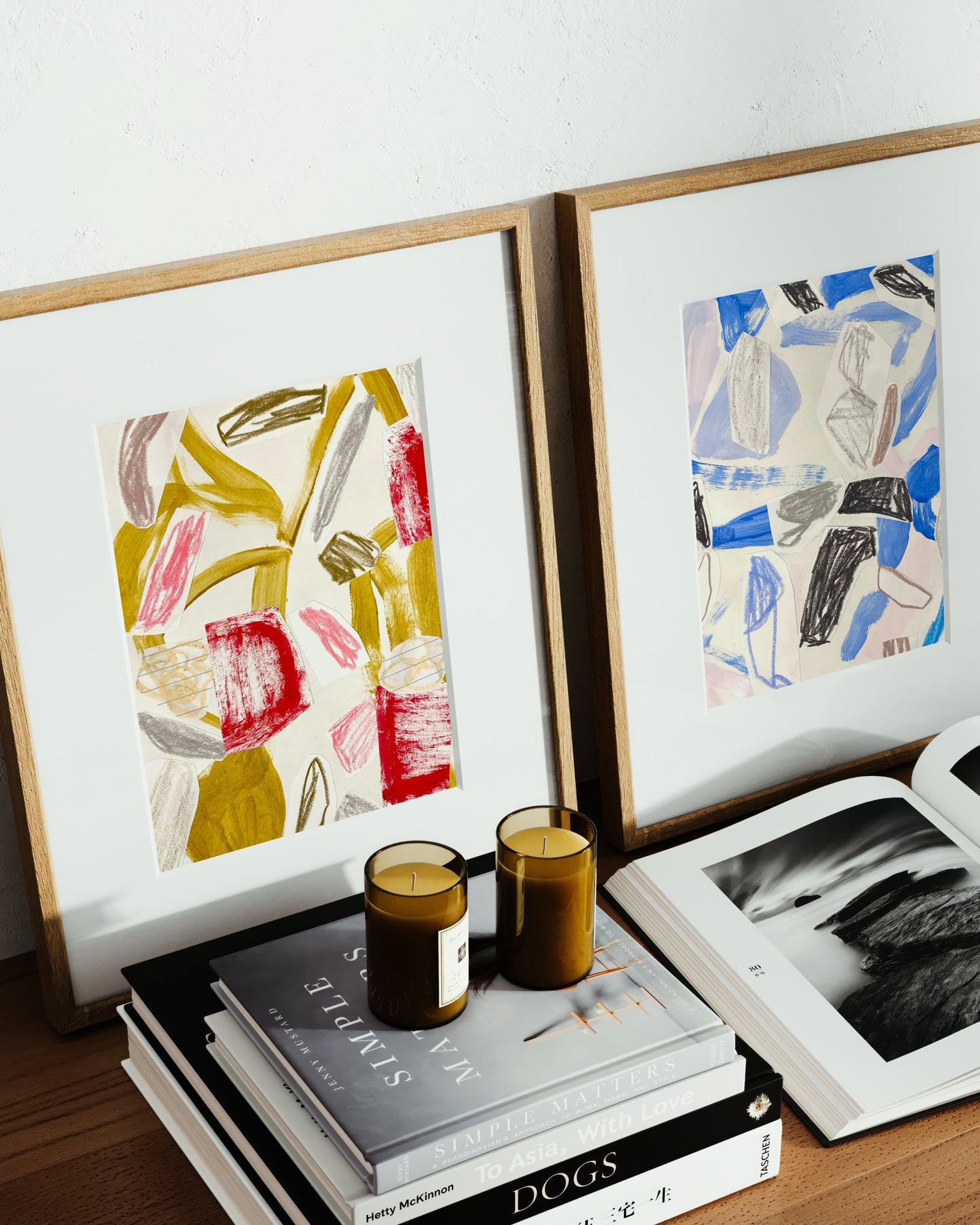 Framed abstract art pieces on a shelf.