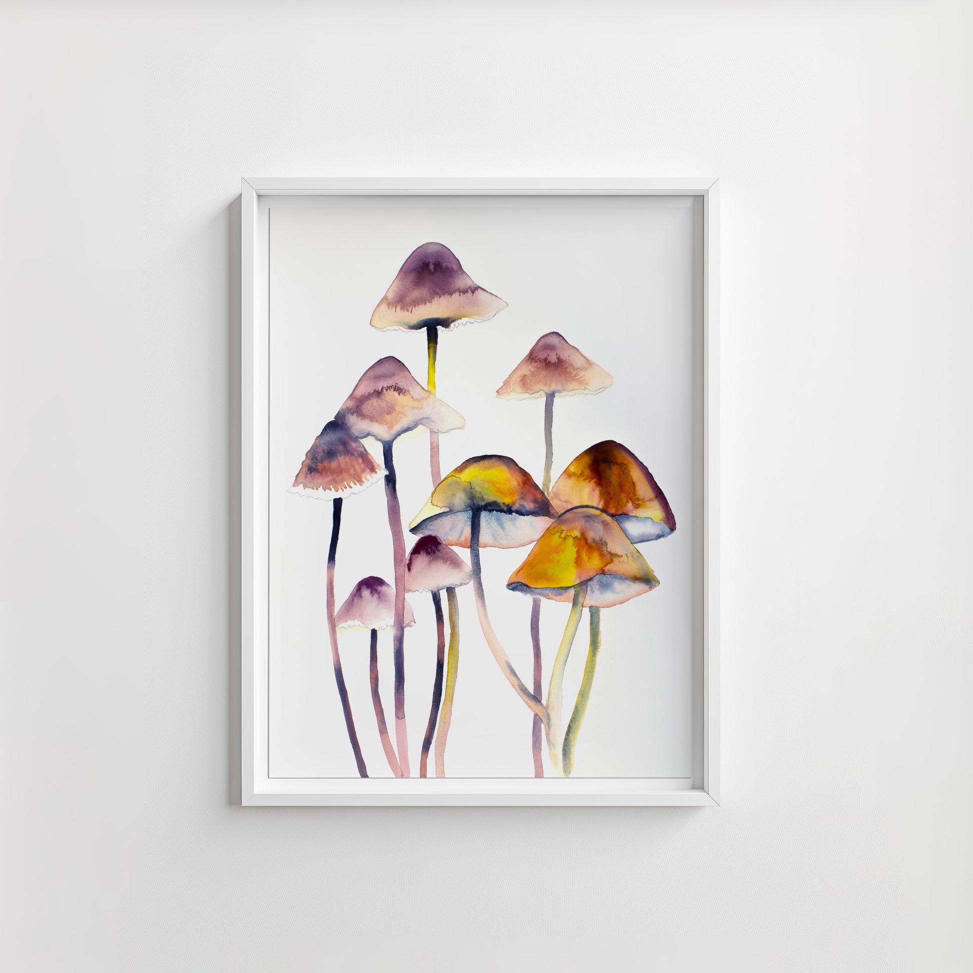 Framed artwork of watercolor mushrooms on a white wall