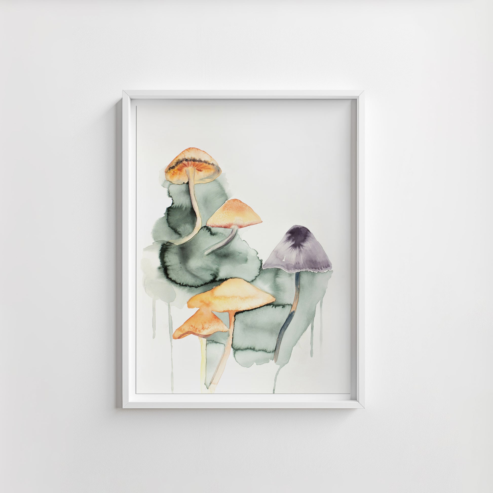 Framed artwork of watercolor mushrooms on a white wall.