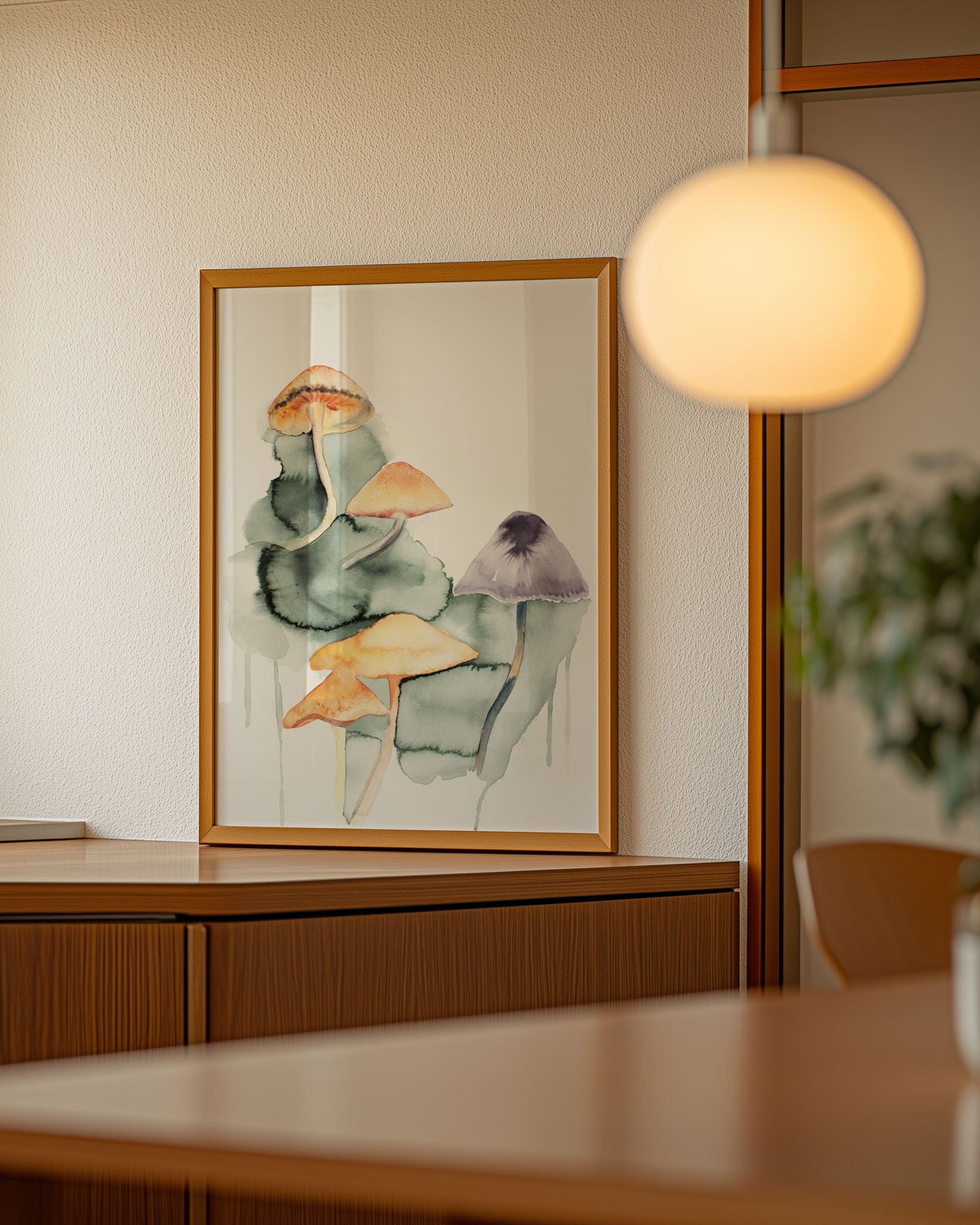 Framed mushroom painting on a wall.