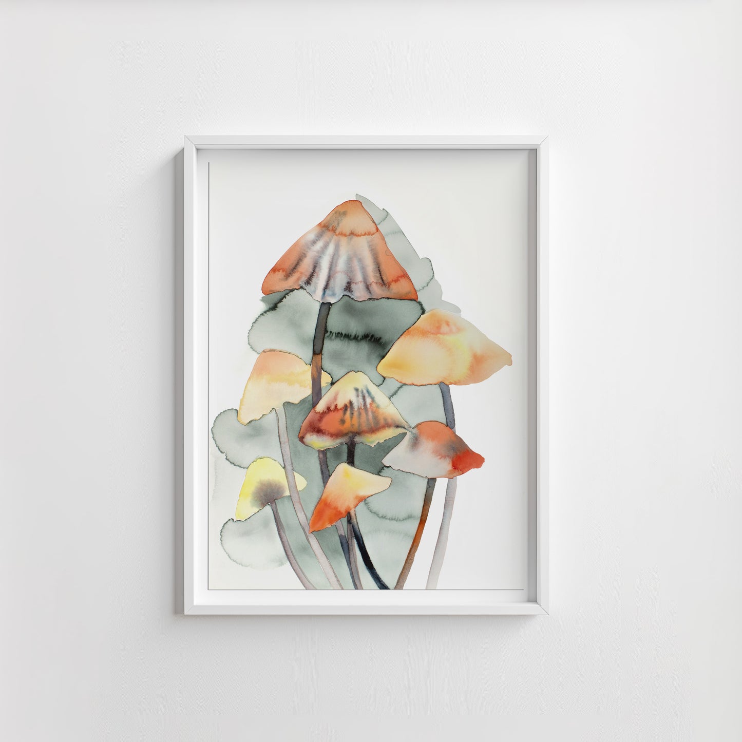 Framed artwork of watercolor mushrooms on a white wall