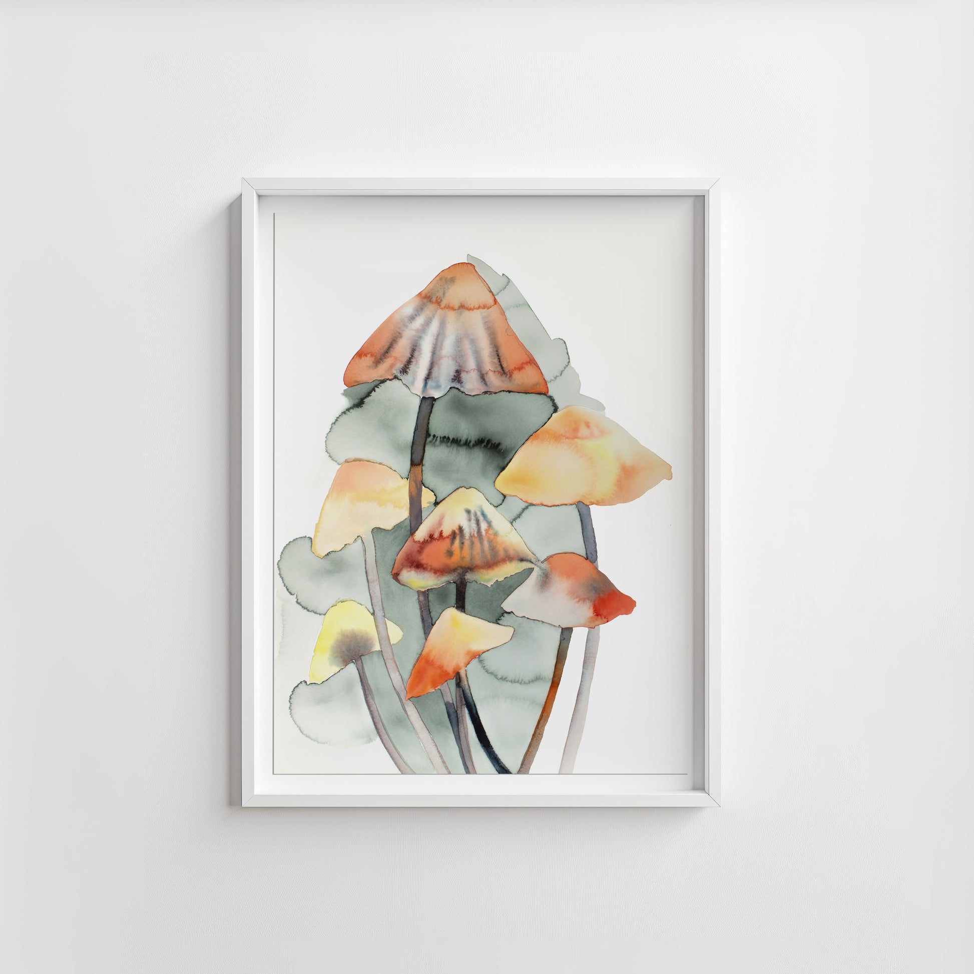 Framed artwork of watercolor mushrooms on a white wall