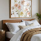 Bedroom with floral artwork above the bed