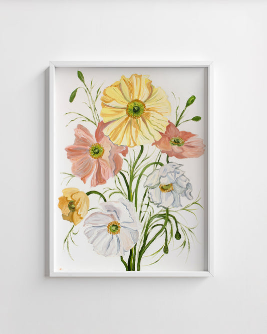 Framed floral artwork with yellow, pink, and white flowers on a white wall.