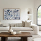Modern living room with a white sofa, and and blue floral painting.