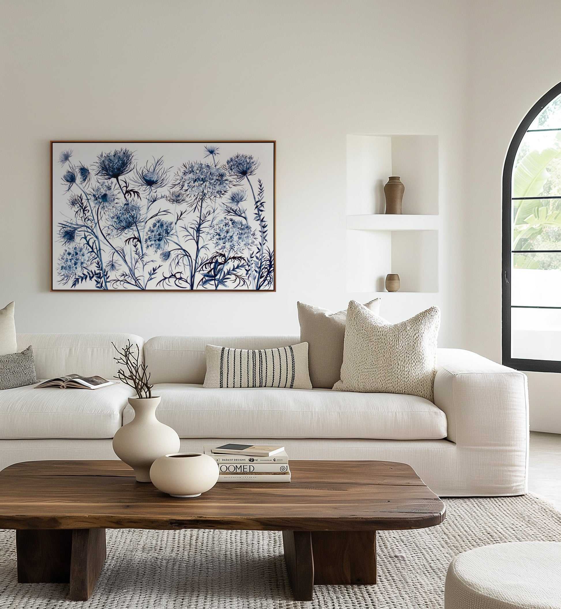 Modern living room with a white sofa, and and blue floral painting.