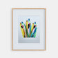 Framed colorful abstract artwork on a white wall